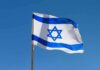 Israeli flag waving against a clear blue sky