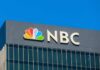 Live-TV Showdown: Senator Hits Back NBC logo on a modern office building facade