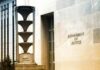 Department of Justice building exterior with sign and metal sculpture