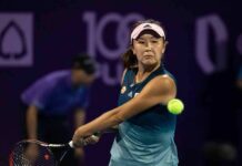 tennis player hitting a backhand shot