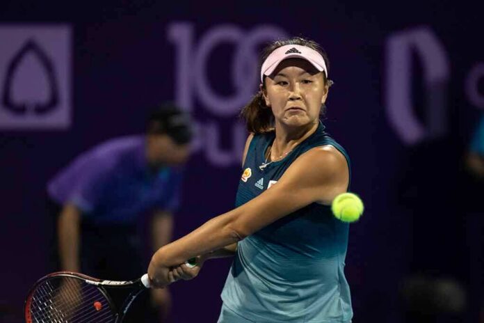 tennis player hitting a backhand shot