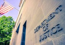 Department of Justice building facade with American flag