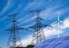 Power lines with wind turbine and solar panels