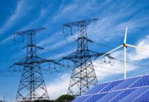 Power lines with wind turbine and solar panels