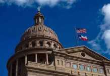 Texas State Capitol dome with U.S. and Texas flags