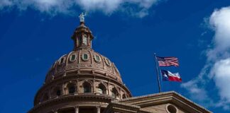 Texas State Capitol dome with U.S. and Texas flags