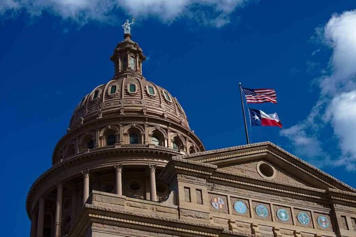 shutterstock_1673539927 Texas State Capitol dome with U.S. and Texas flags