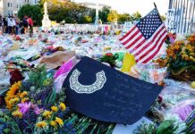 Memorial site with flowers and a U.S. flag