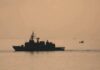 naval ship silhouette at sea during sunset
