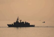 naval ship silhouette at sea during sunset