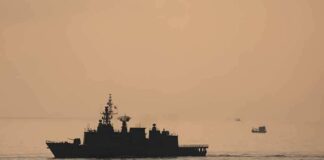 naval ship silhouette at sea during sunset