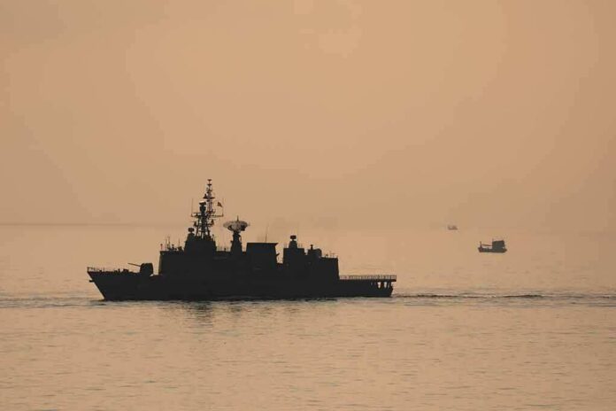 naval ship silhouette at sea during sunset