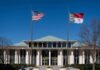government building with US and state flags at the entrance