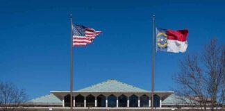 government building with US and state flags at the entrance