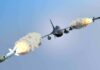 fighter jet firing two missiles in flight