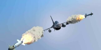 fighter jet firing two missiles in flight
