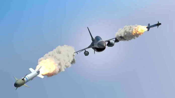 fighter jet firing two missiles in flight