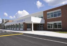 Congress Targets Chicago Schools’ Gender Rules Modern school building with large windows and a clear sky