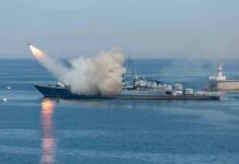 Warship launching a missile at sea