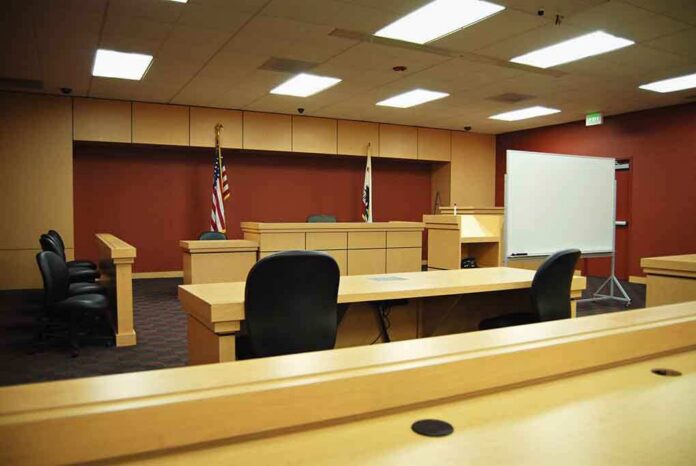 shutterstock_6768826 Interior view of an empty courtroom with wooden furniture and American flags
