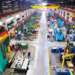 Aerial view of a large industrial workshop filled with various machinery and equipment