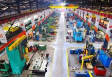 Manufacturing Mirage Rattles Main Street Aerial view of a large industrial workshop filled with various machinery and equipment