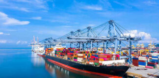 Container ship docked at a busy industrial port.
