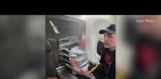 American Airlines passenger restrained with duct tape and handcuffs, plane makes emergency landing