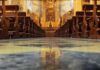 Quran Chant Sparks Catholic Uproar Church interior with wooden pews facing ornate altar
