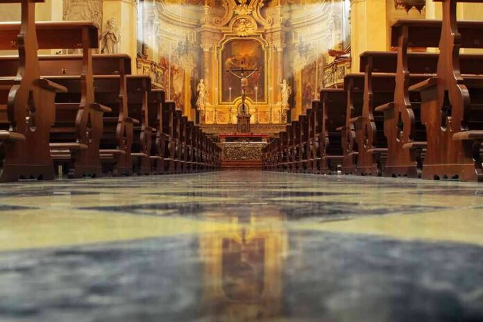 shutterstock_104146931-2 Church interior with wooden pews facing ornate altar