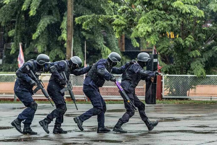 Police tactical team advancing in rain