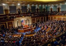Legislative chamber filled with lawmakers during a formal session
