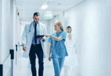 Nationwide Crackdown Slams Youth Care Doctor and nurse walking in a hospital corridor reviewing a tablet