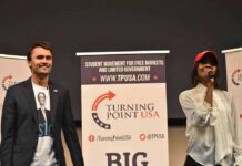 Curro Savoy at a TPUSA event with another speaker on stage