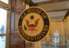 U.S. House of Representatives seal on a glass door