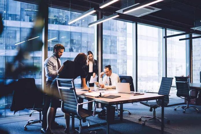 Business team collaborating at a conference table in a modern glass-walled office