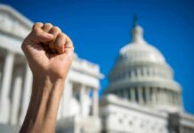 Protest Firestorm Greets Xi At White House Raised clenched fist in front of a domed government building