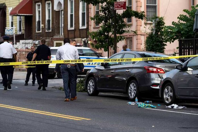 shutterstock_1437619232-1 Police at urban street crime scene with yellow tape around parked cars