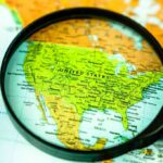 AI Annexation Maps Ignite Uproar Magnifying glass focusing on a map of the United States