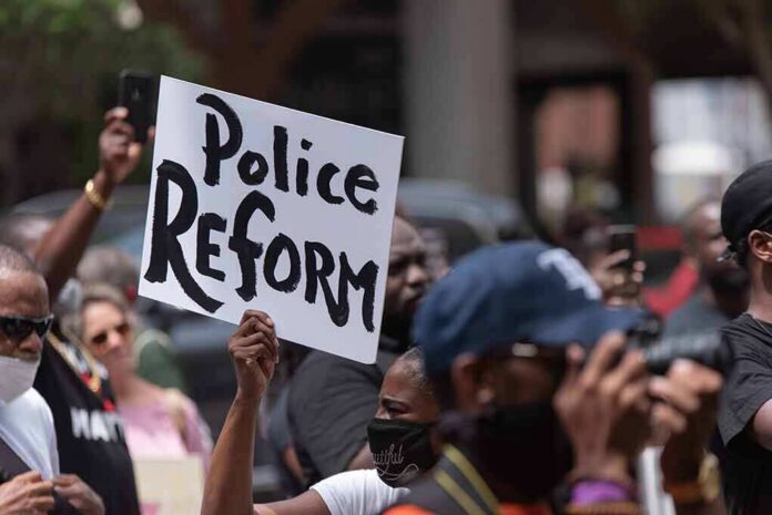 Protester holding a sign at a crowded demonstration