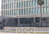 Embassy building behind tall black security fence