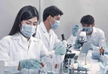 Anthropic’s Shadow Lab Sparks Bio Jitters Scientists in lab coats working with test tubes and microscopes