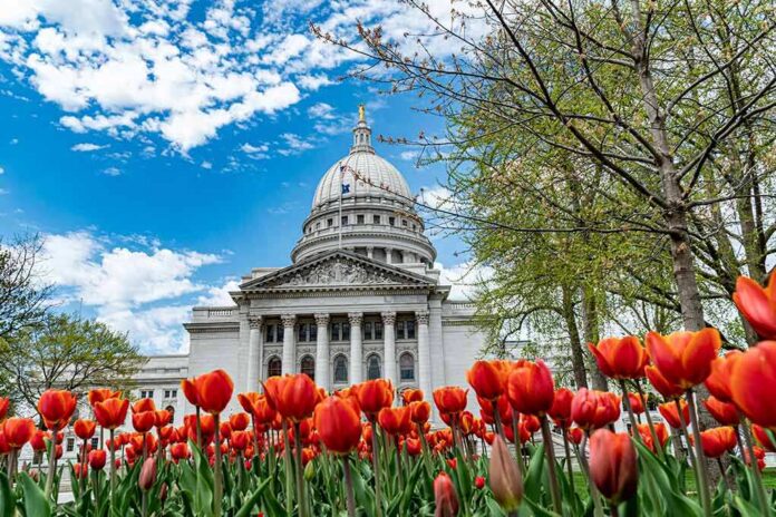 Capitol building framed by red tulips under a blue sky