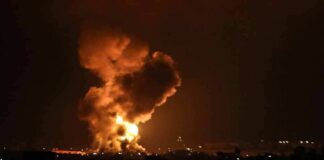 Large explosion with fireball and smoke at night