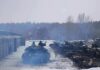 tanks lined up in a snowy motor pool