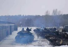 tanks lined up in a snowy motor pool