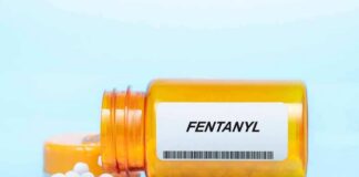 Orange pill bottle labeled Fentanyl with white tablets spilled out