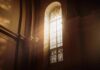 sunlit stained glass window in a church interior