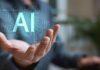 Hiring Bombshell: AI Slams Women’s Paychecks Hand holding glowing AI hologram