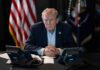 Nationwide Watchlists? Trump Tips The Scale Person in suit seated at table with telephones